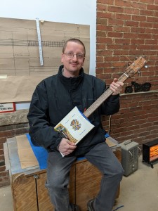 NK with Cigar Box Guitar 3.jpg